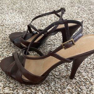 Dark brown, size 7, heels with adjustable straps.